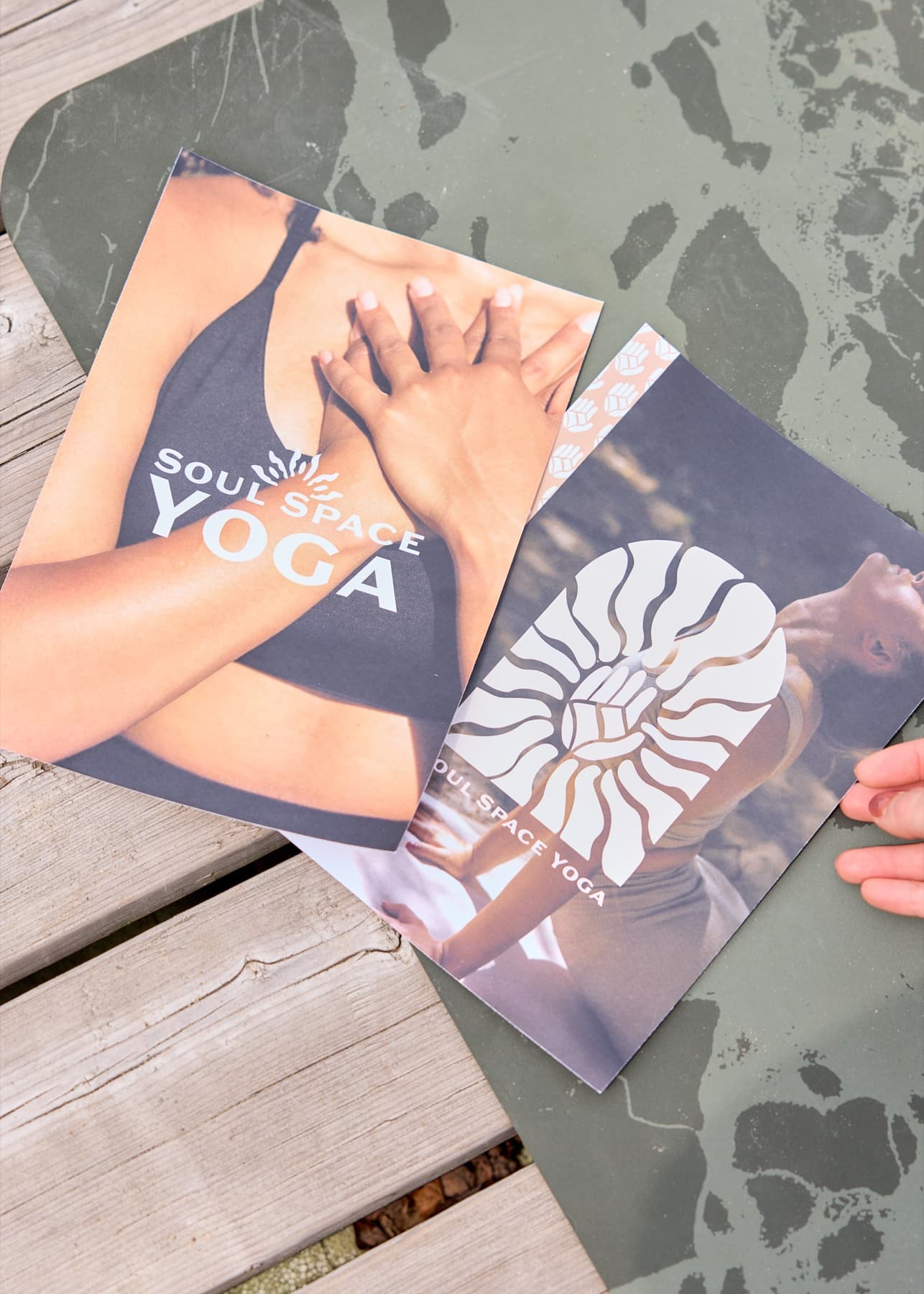 Printed Soul Space Yoga identity cards photographed outdoors