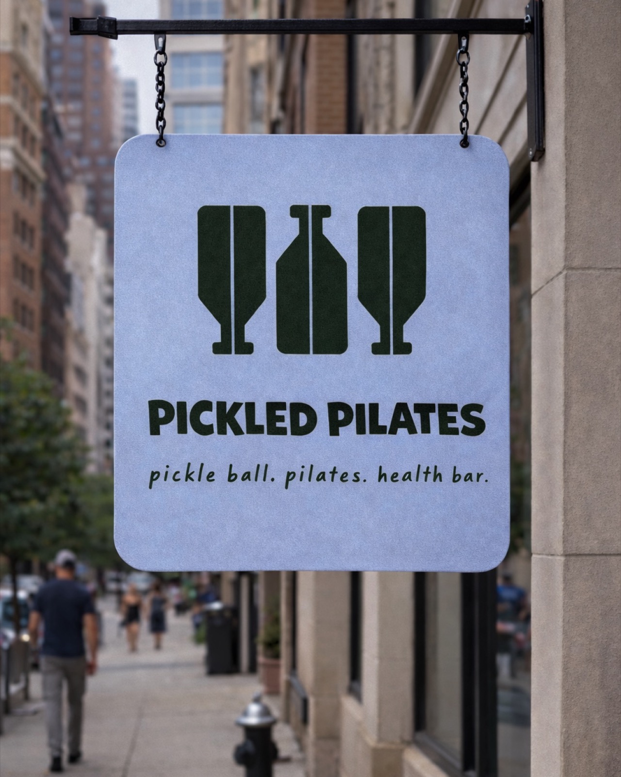 Pickled Pilates hanging street sign with paddle and bottle icons